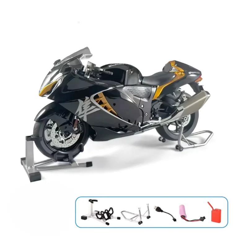 Moto de collection miniature Suzuki Hayabusa 1/6 noire avec accessoires complets exposés : béquilles, batterie, réservoir, éléments de fumée et pièces de démonstration, illustrant la qualité premium et les fonctions interactives.